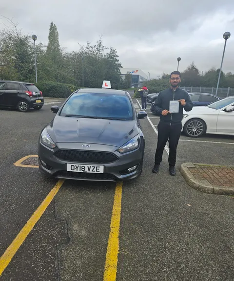 Pupil holding a pass certificate at Enfield driving test centre
