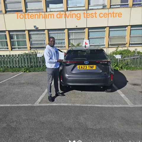 Pupil holding a pass certificate at Tottenham driving test centre